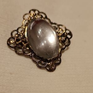 Ornate bronze and reflective glass vintage brooch